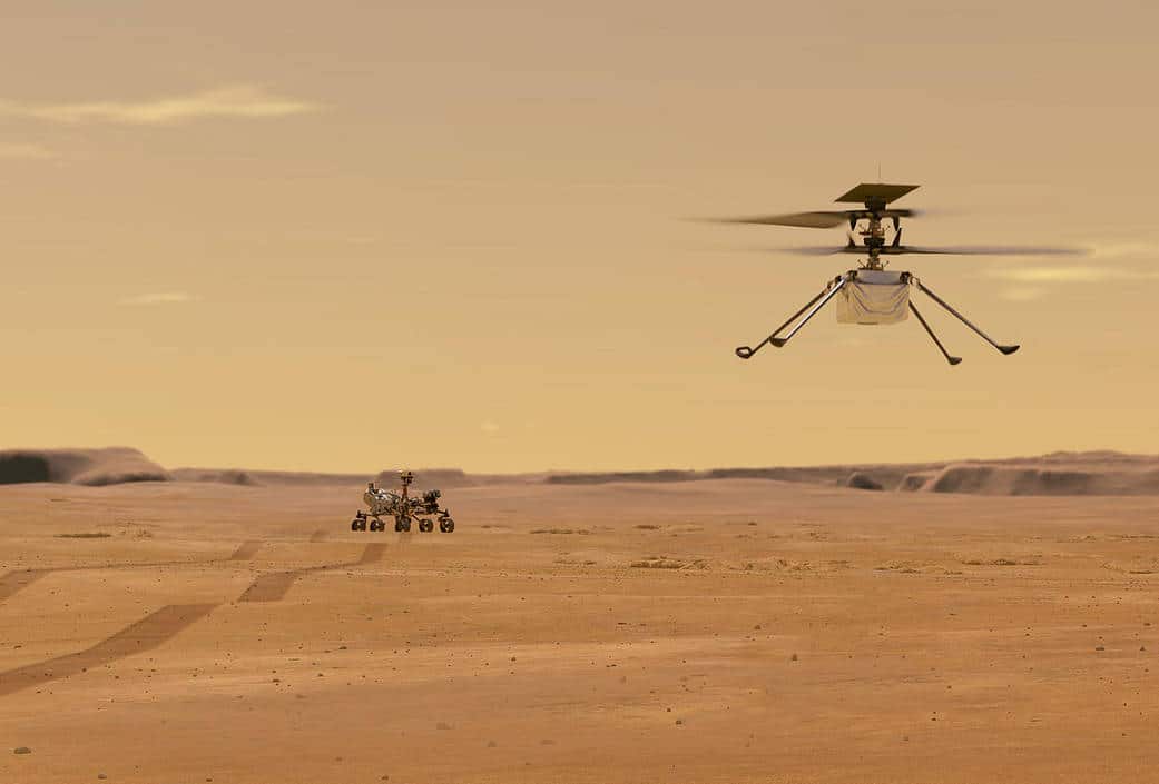Illustrazione di Ingenuity durante un volo di prova su Marte e il rover Perseverance sullo sfondo. Credits: NASA/JPL-Caltech