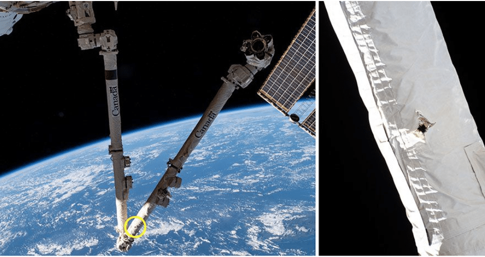 Questa immagine del braccio robotico Canadarm2 mostra il punto dell’impatto con il detrito spaziale sulla ISS. Credits: NASA, Canadian Space Agency