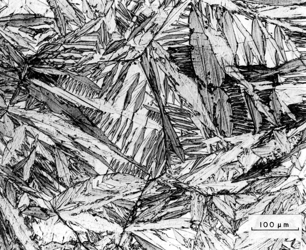 Micrografia di un acciaio temprato tramite raffreddamento in azoto liquido. Le strutture “aghiformi” sono costituite da martensite, mentre la fase bianca è austenite residua.