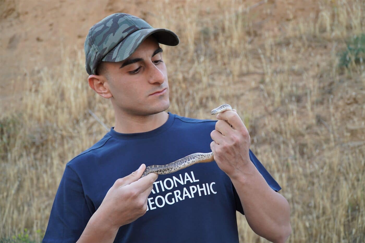 Sebastian Colnaghi con in mano un esemplare di Boa delle sabbie. Credits: Sebastian Colnaghi