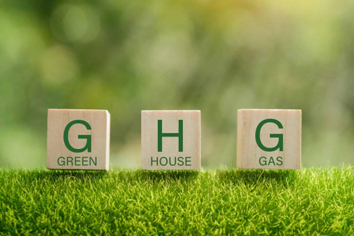Gas fluorurati, l'Europa accelera il loro phase-out per gli effetti sul clima - Business and GHG concept. Copy space. Greenhouse gas symbol. Concept words 'GHG, greenhouse gas' on cubes and blocks on a beautiful green background.