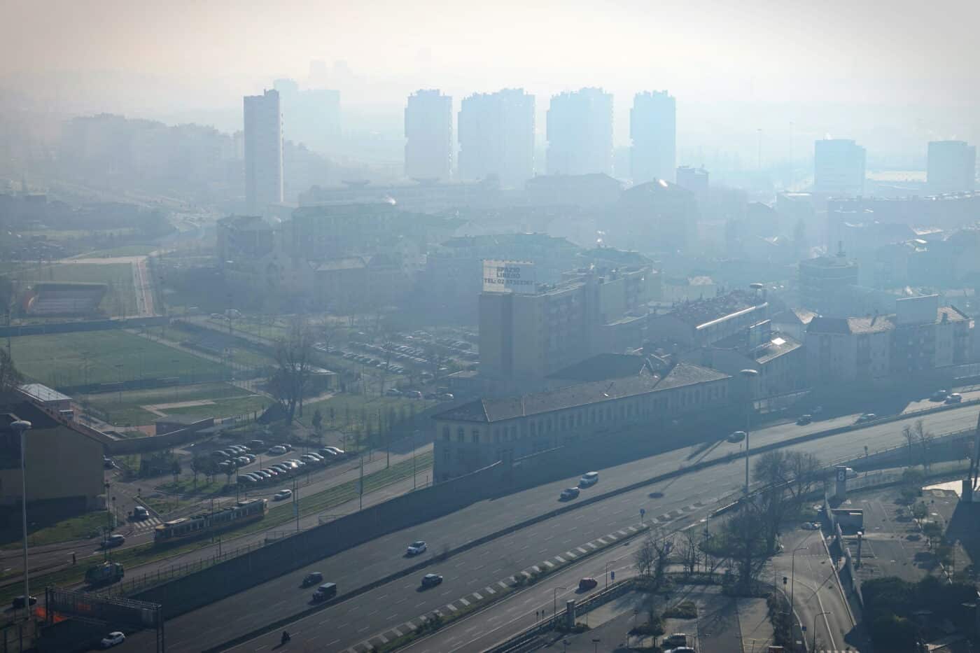 Milan landscape with smog, aerial view of the city with polluted air.