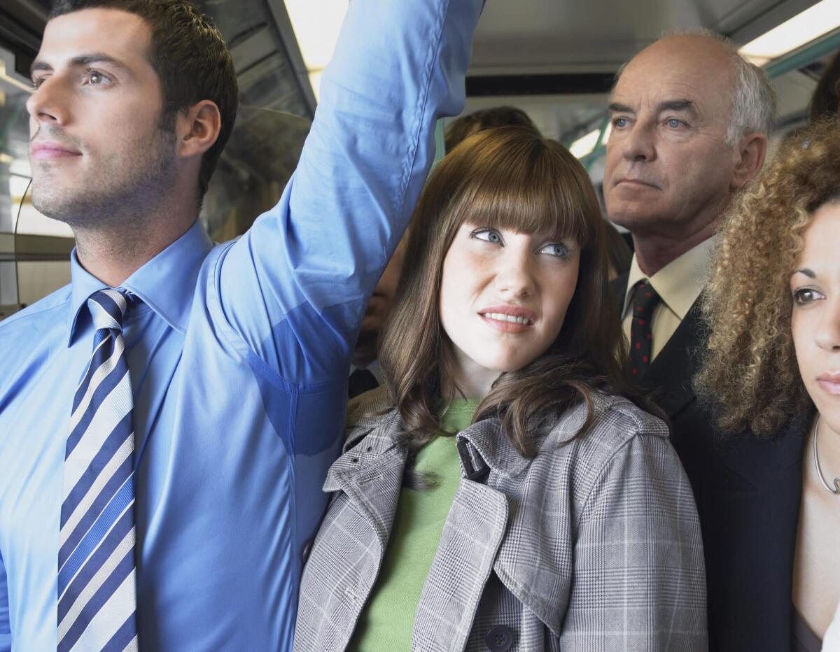 Arriva una nuova terapia per l'iperidrosi - Commuter Standing by Man's Wet Armpit on Train