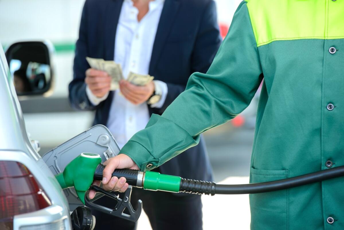 Via i contanti, a Cuba la benzina solo con la carta - Businessman give money dispensers, filled car on gas station