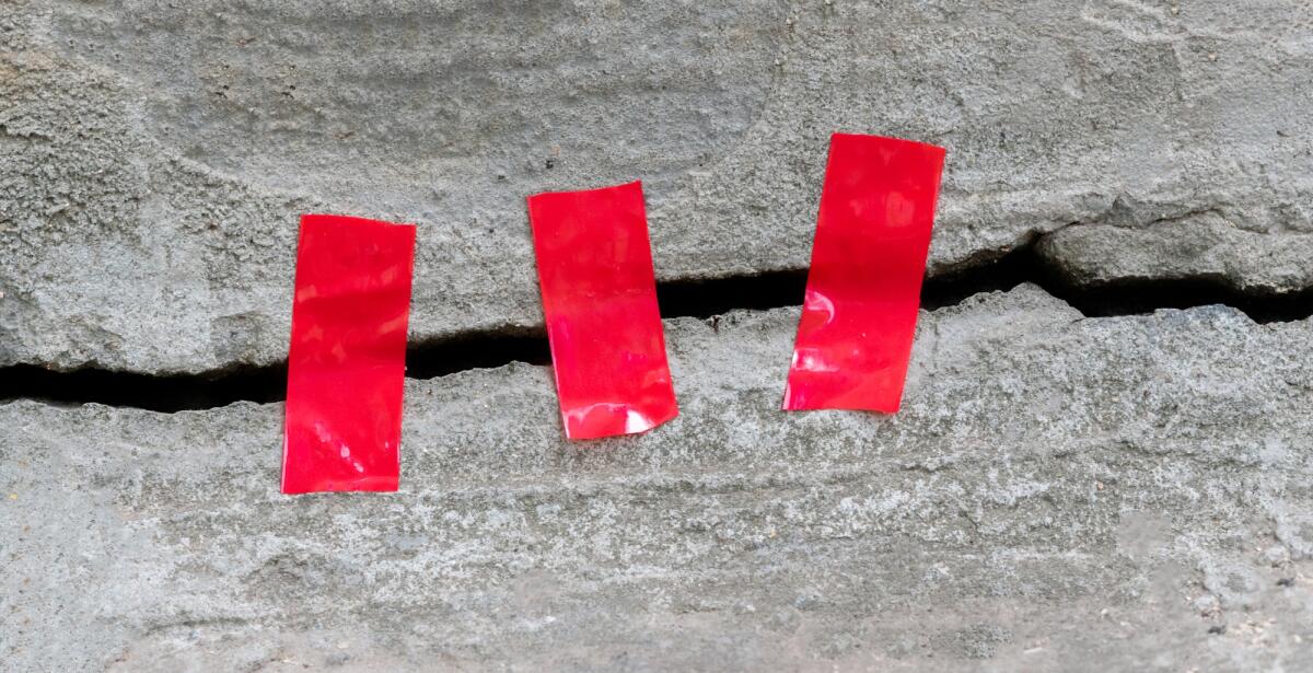 Terremoto in Marocco di magnitudo 6.8: oltre 600 vittime - a crack in the concrete, symbol of the earthquake disaster catastrophe, sealed with a tape, help concept