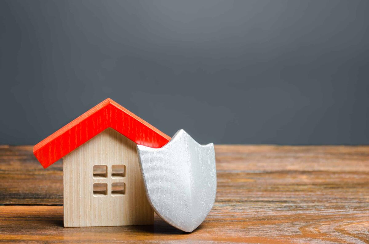 Gli atti degli abusi edilizi saranno accessibili ai cittadini - House figurine and protective shield. The concept of home security and safety. Alarm systems. The inviolability of private property, protection against raiders or unauthorized access.