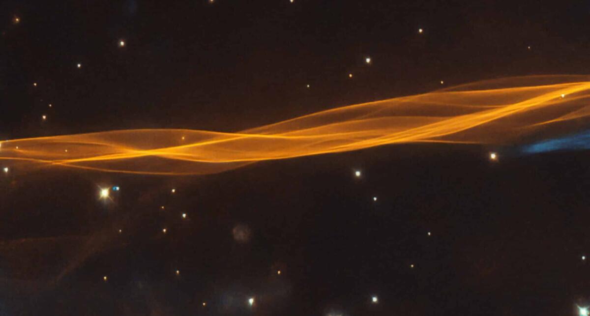 Anello del Cigno, fotografato il residuo di una supernova - While appearing as a delicate and light veil draped across the sky, this image from the NASA/ESA Hubble Space Telescope actually depicts a small section of the Cygnus supernova blast wave, located around 2400 light-years away. The name of the superno