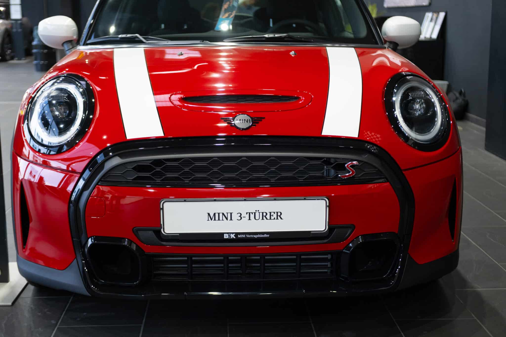 Red Mini Cooper BMW of automotive concern BMW Group closeup, British Motor Corporation BM? in showroom, car dealership, Advertising and Marketing in Automotive Industry, Frankfurt - October 11, 2023