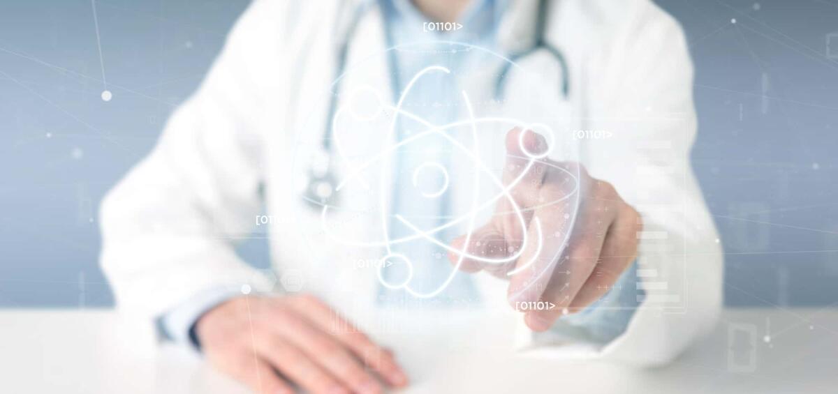Cinque modi in cui il Nucleare aiuta i pazienti oncologici - View of a Doctor holding an atom icon surrounded by data