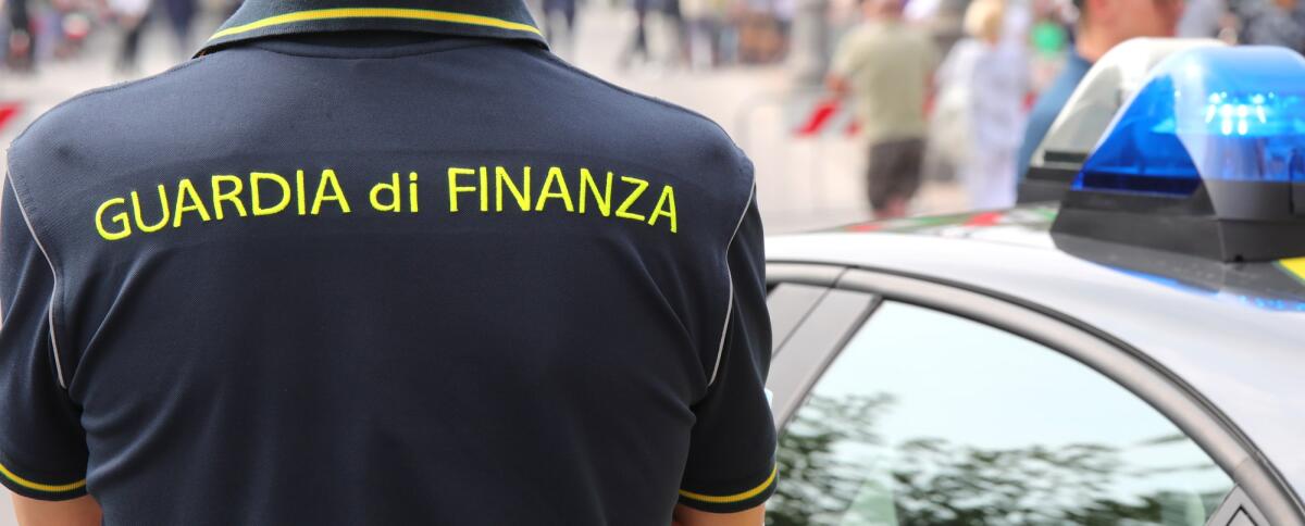 Operazione "Black Friday": sequestrati oltre 140 mila prodotti contraffatti a Napoli - Vicenza, VI, Italy - June 2, 2022: Policeman with uniform and text GUARDIA DI FINANZA that means Financial Police in italian language and the car