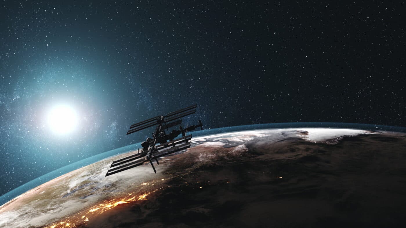 ISS rotate Earth atmosphere distant exploration. International Space Station against realistic night illuminated mainland. Sunrise over planet orbit. 3d animation. Elements of media furnished by NASA