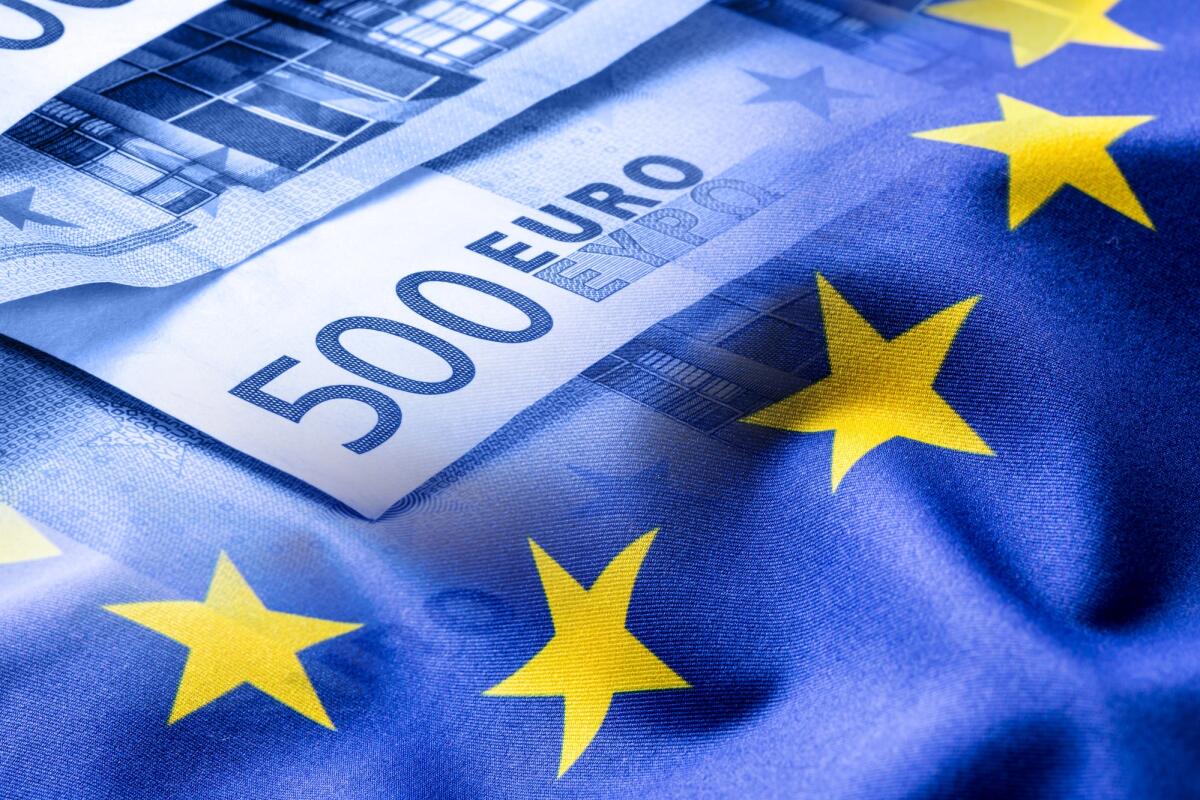 La Camera dei Deputati vota contro la ratifica del MES - Euro flag. Euro money. Euro currency. Colorful waving european union flag on a euro money background.
