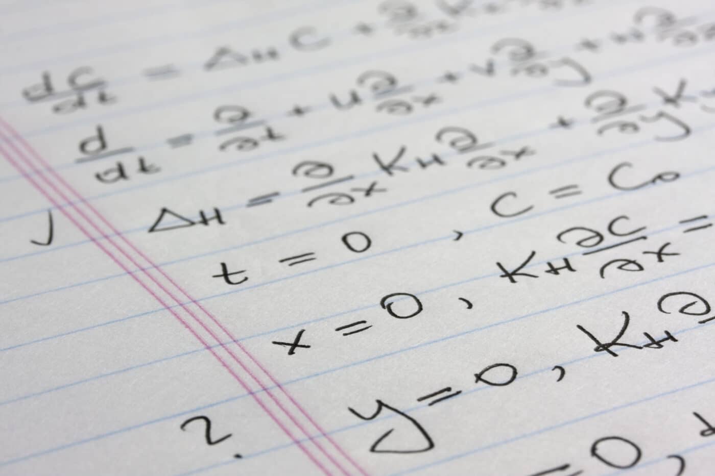 differential equation (concentration transport model) with boundary and initial conditions handwritten with black pen on notepad paper, macro shot with selective focus