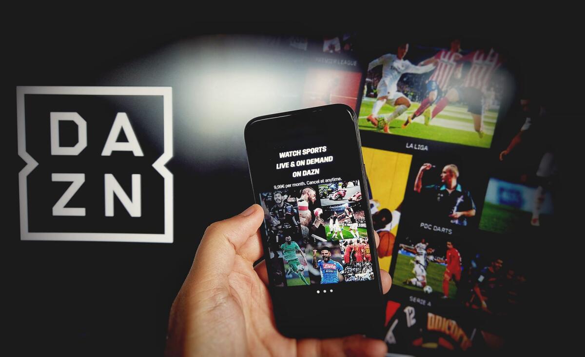 Dazn e Publitalia rinnovano la sinergia per la pubblicità sulla Serie A - DAZN app for mobile phone with DAZN background on computer screen. DAZN is an english subscription sports streaming service with on demand and live events in Bologna, Italy, 28 Aug 2020