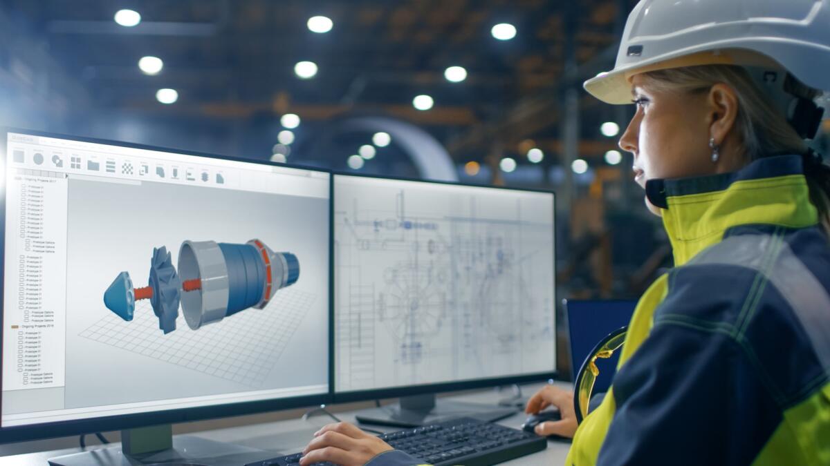 Il 4 marzo è la Giornata Mondiale dell'Ingegneria - Inside the Heavy Industry Factory Female Industrial Engineer Works on the Personal Computer on the Turbine/ Engine Project in 3D Using CAD Program.